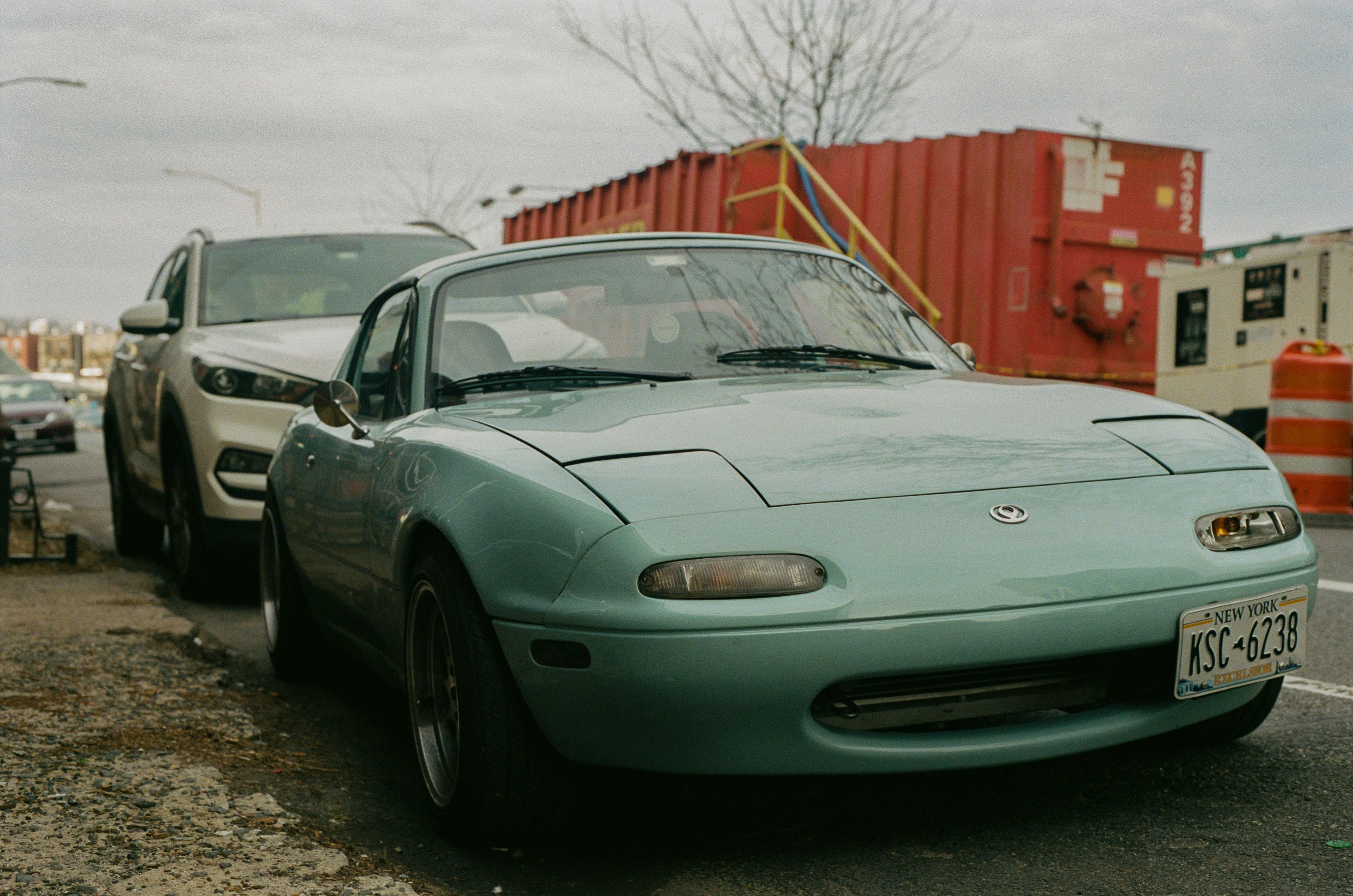 a car parked next to another car in a parking lot