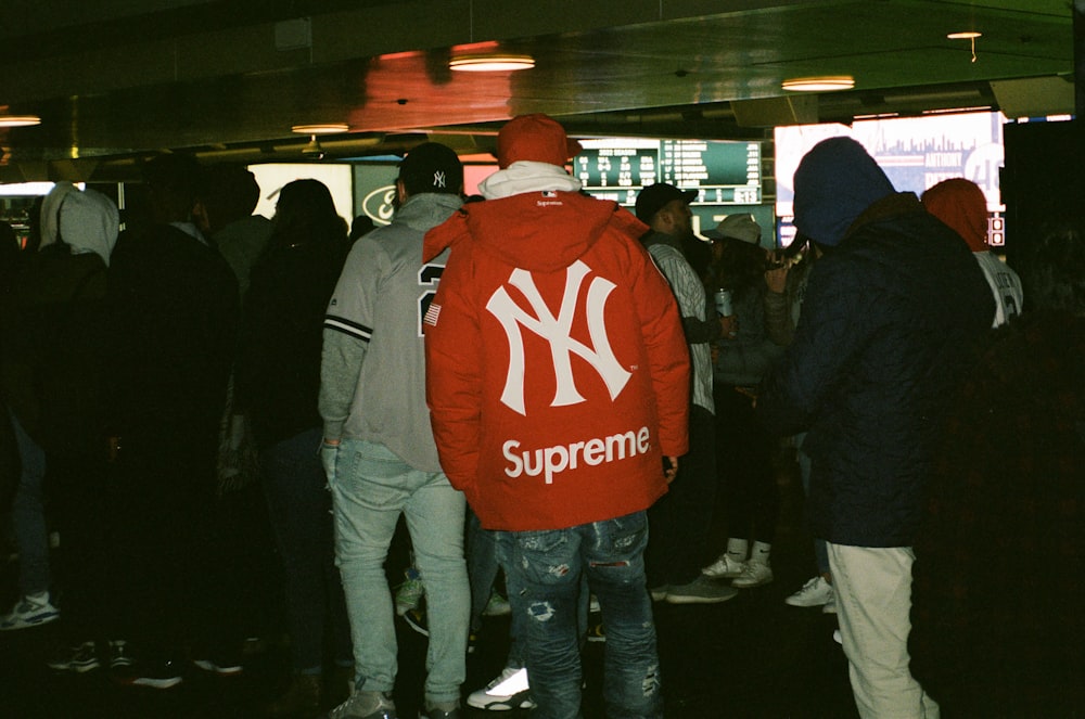 a group of people standing around in a room