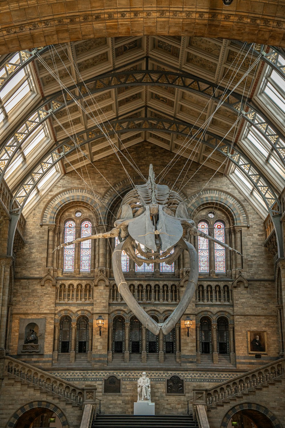 a large building with a statue of a whale hanging from the ceiling
