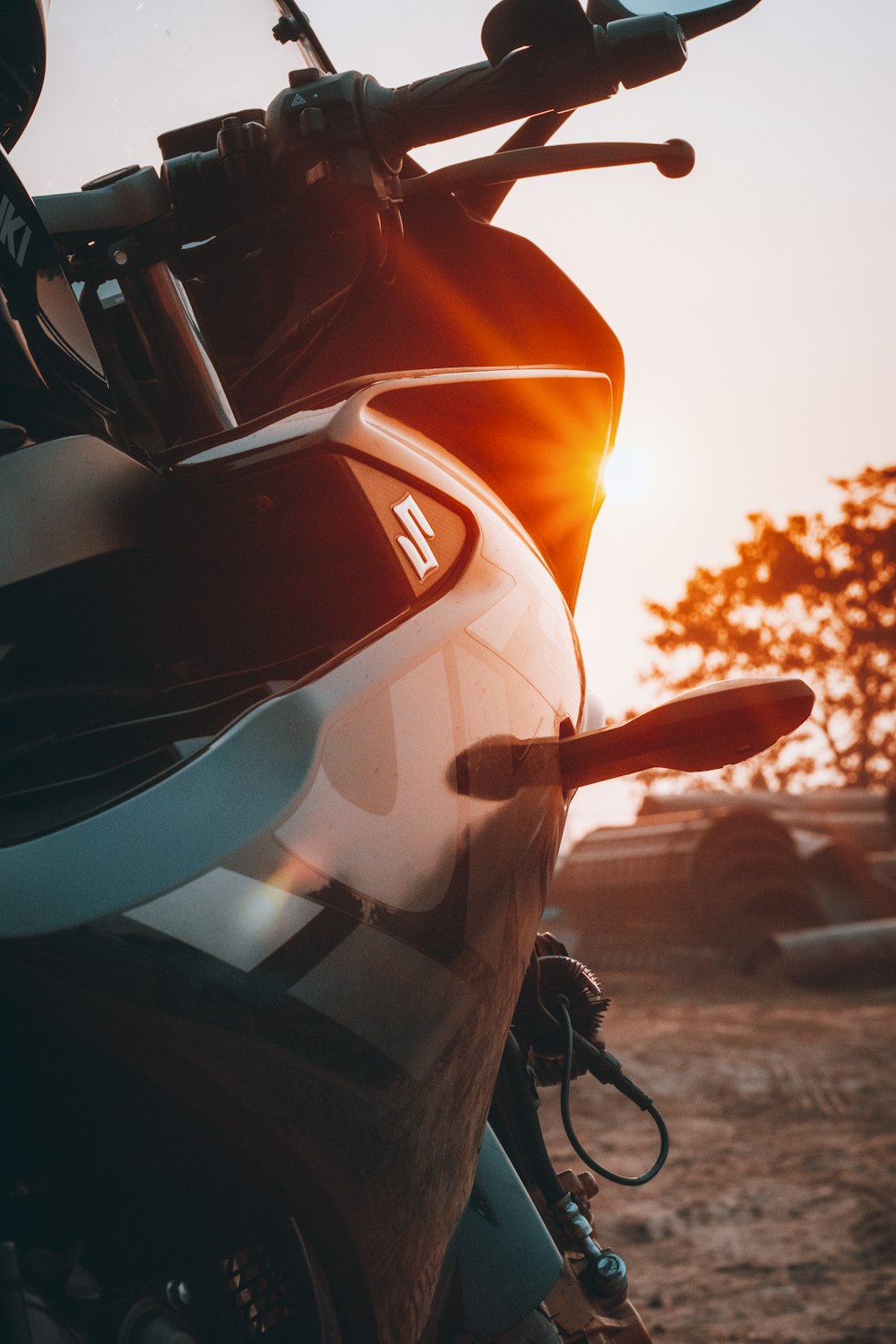 a close up of a motorcycle parked in a field