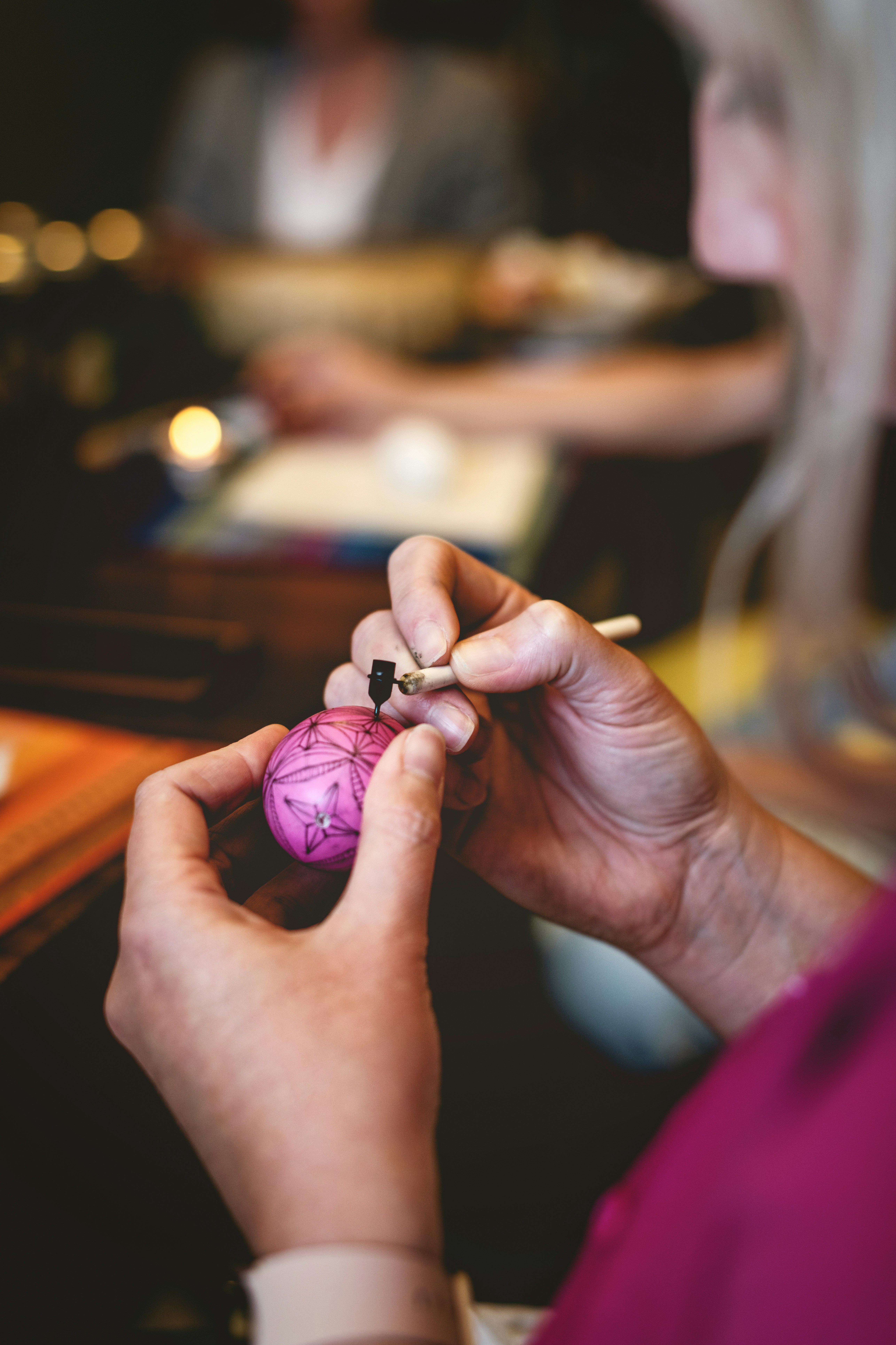 a woman holding a pink object in her hands