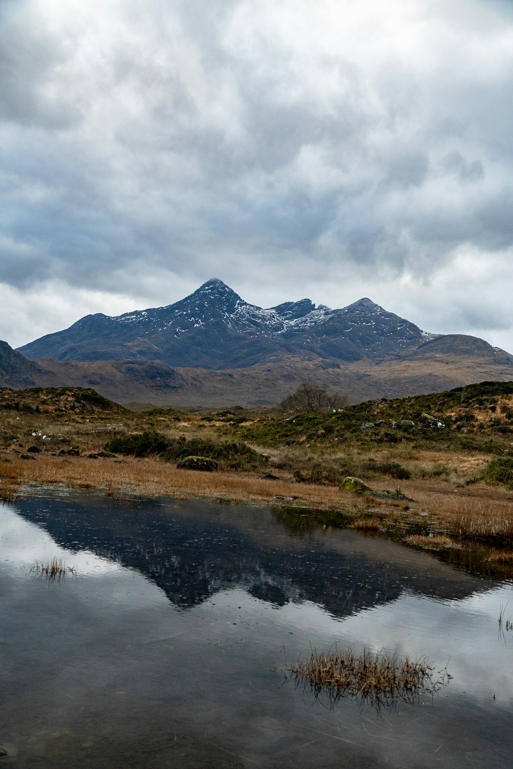 a mountain range with a body of water in the foreground