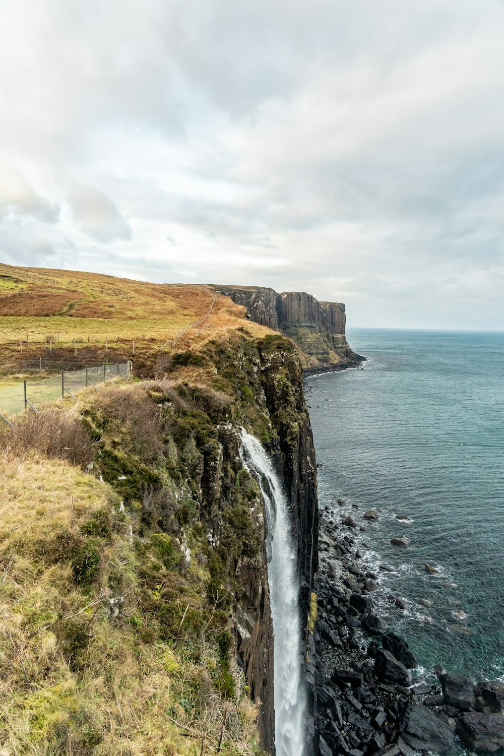 a large waterfall flowing into a body of water