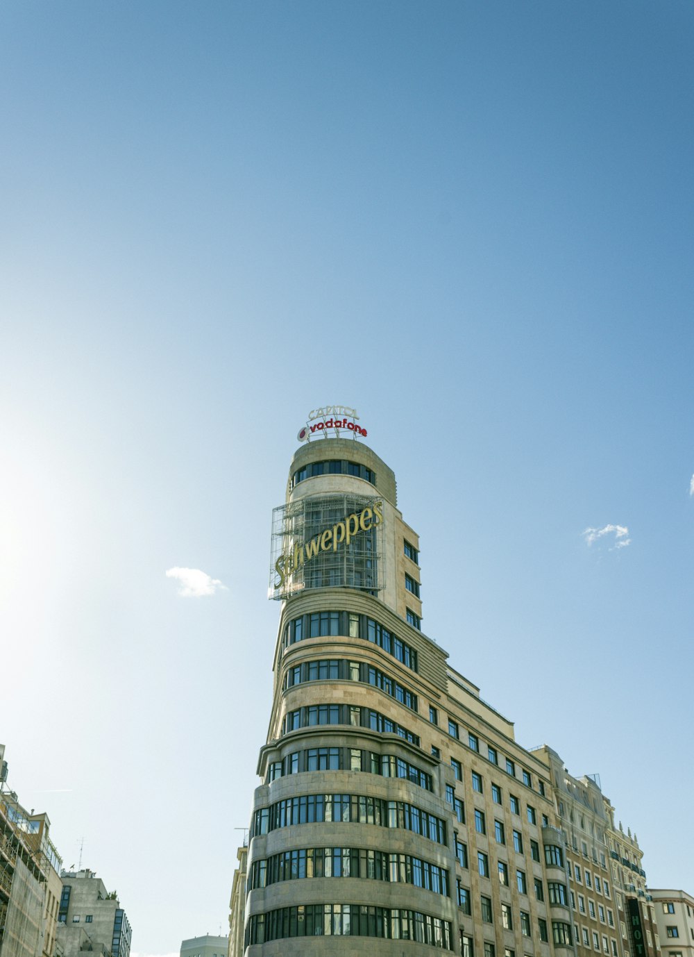 a very tall building with a sign on top of it