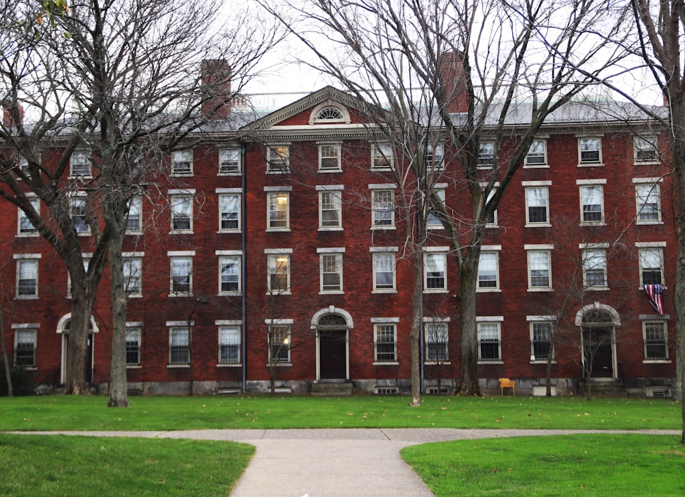 a red brick building with trees in front of it