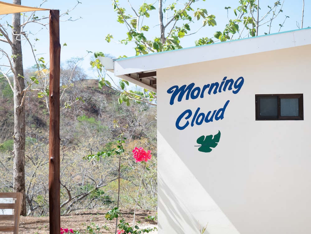 a white building with a blue sign that says morning cloud