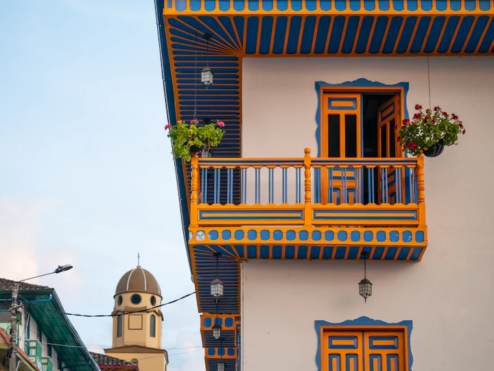 a building with a balcony and a clock tower