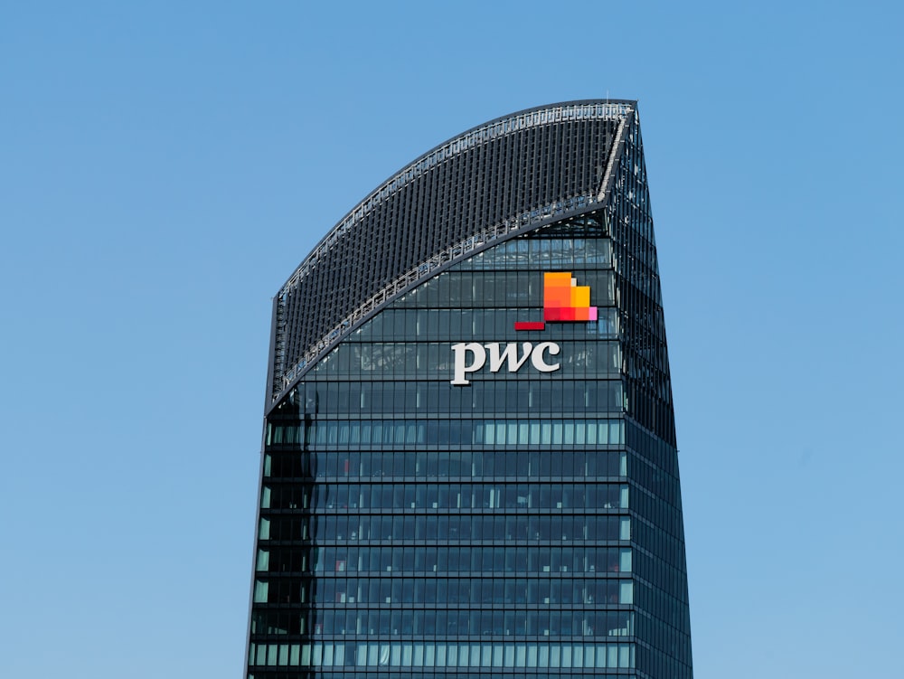 a tall building with a pwc logo on top of it