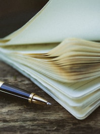 a pen sitting on top of a stack of papers