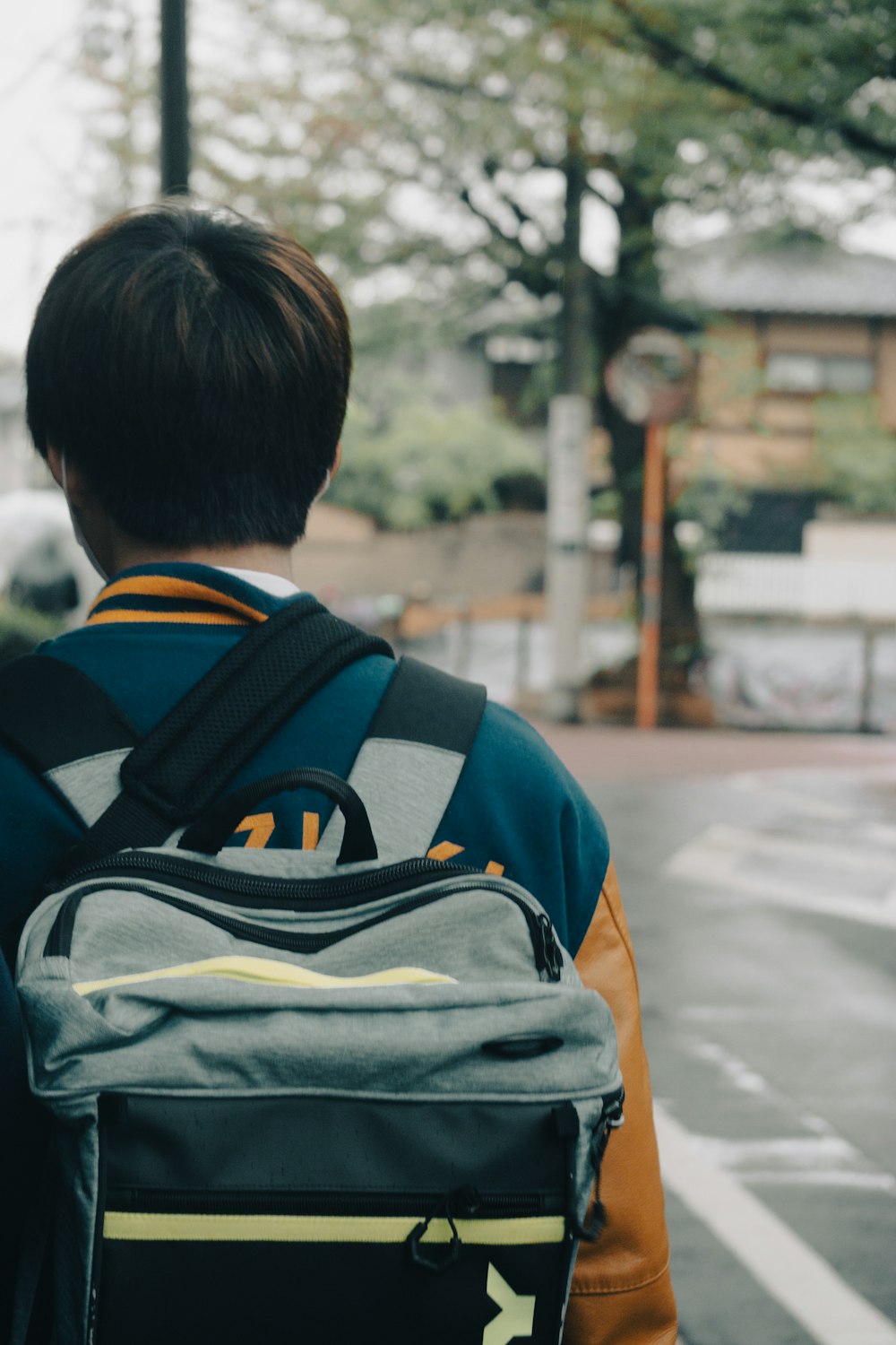 a person with a backpack walking down a street