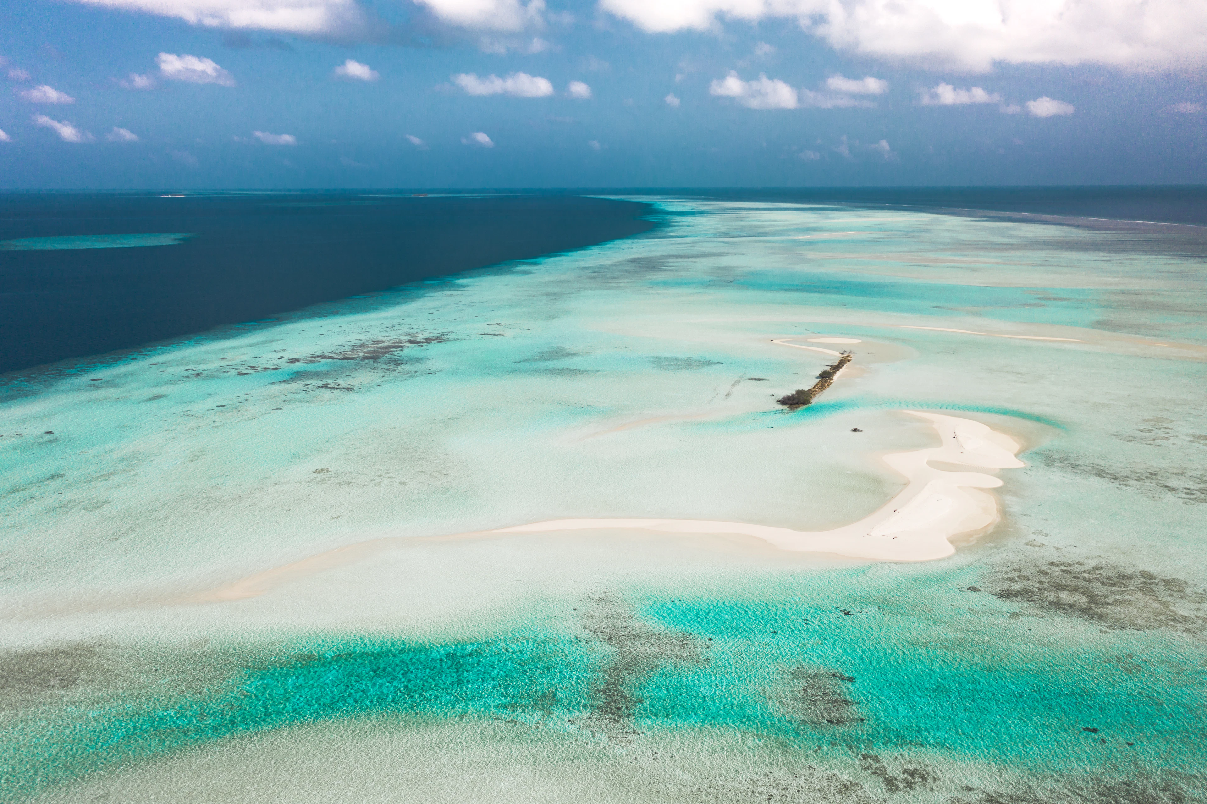 White sandbar in vivid turquoise lagoon water