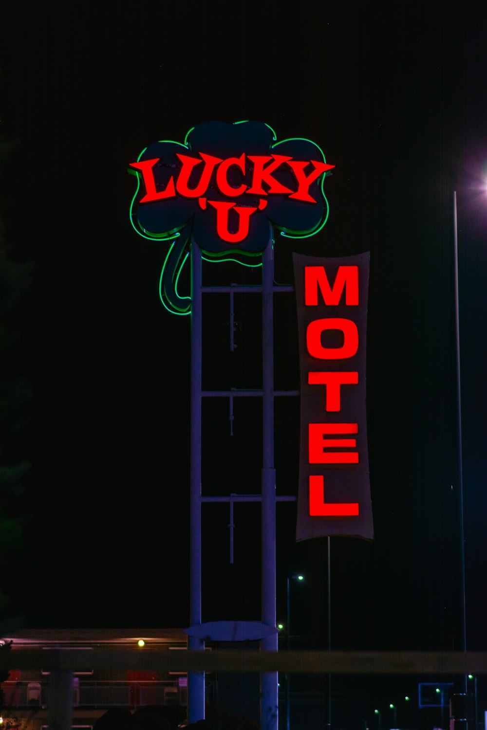 a neon sign for a motel lit up at night