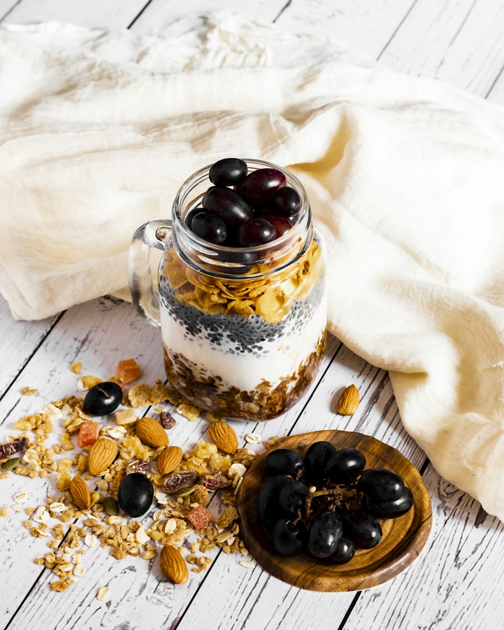 a glass jar filled with granola and black olives