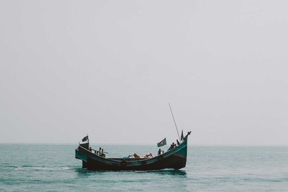 a small boat in the middle of a large body of water