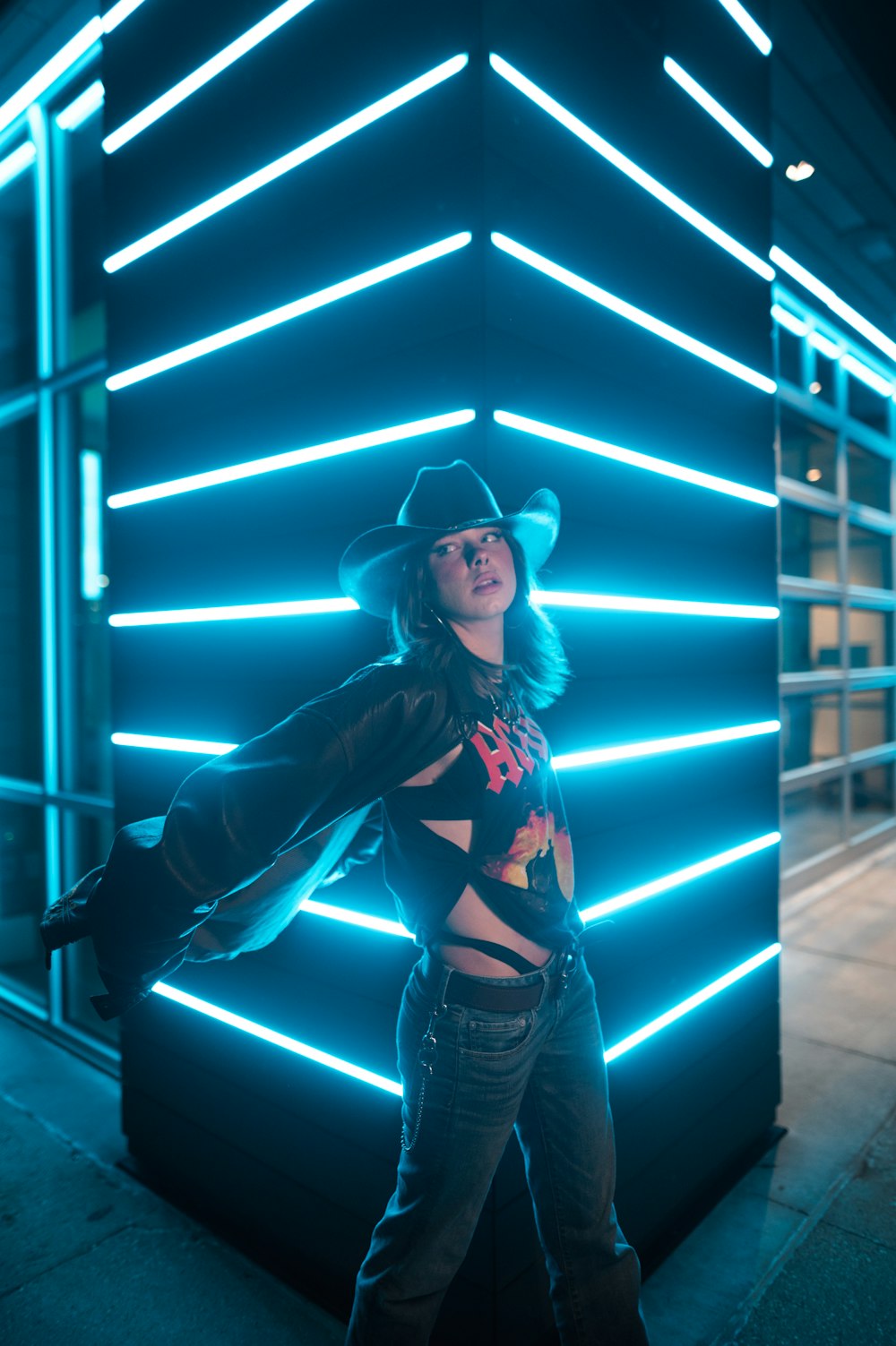 a woman standing in front of a blue light