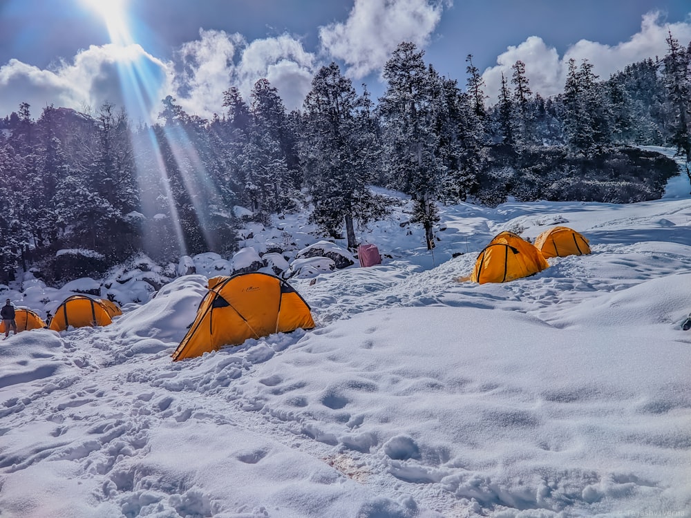 a group of tents pitched up in the snow