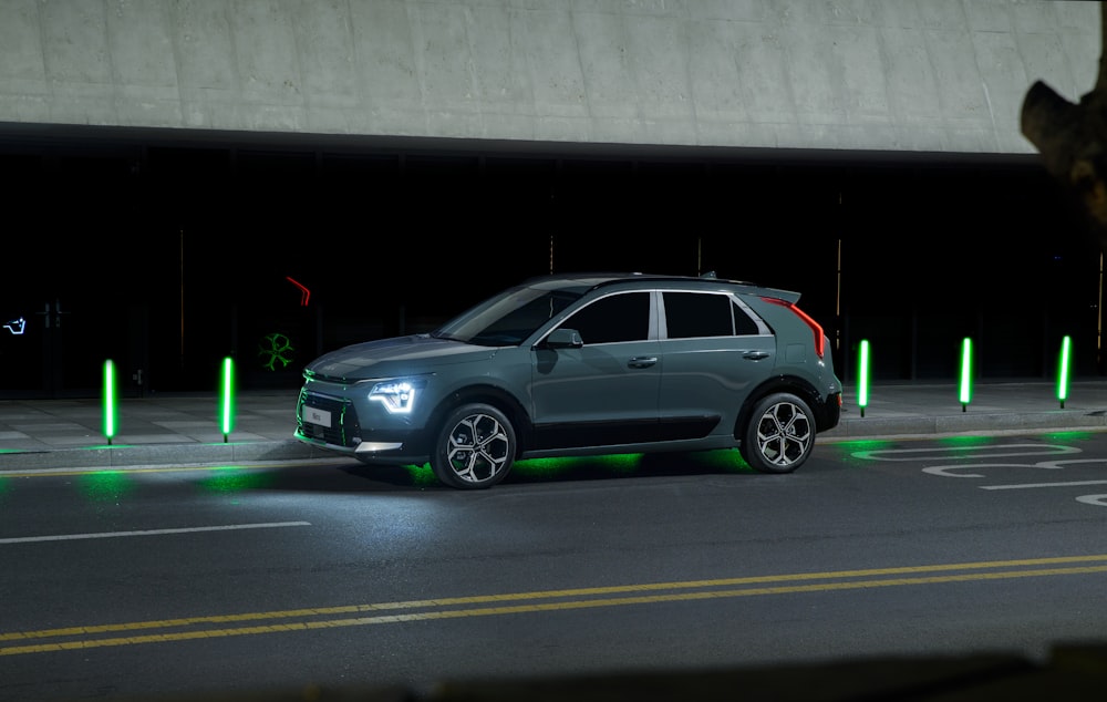 a car driving down a street at night