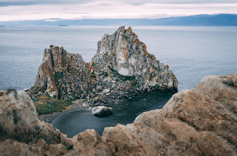 a rock formation in the middle of a body of water