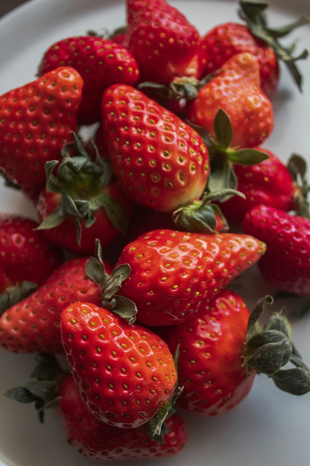 a close up of a plate of strawberries