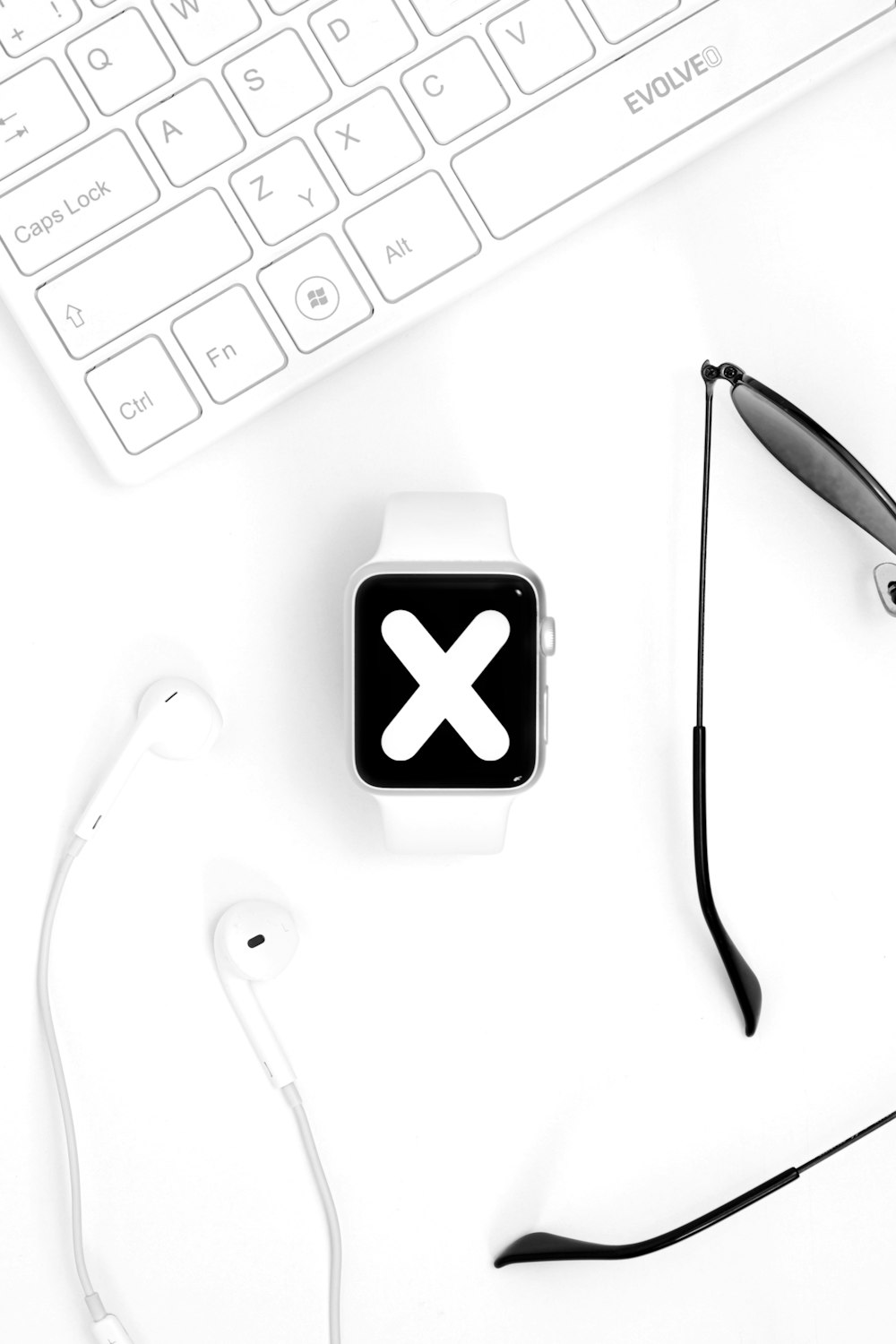 an apple watch sitting on top of a desk next to a keyboard