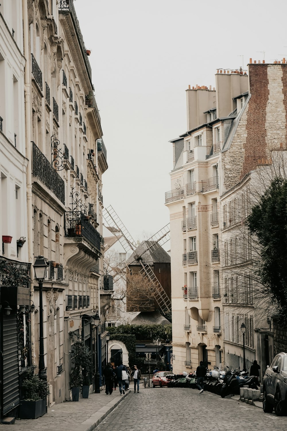 a cobblestone street lined with tall buildings