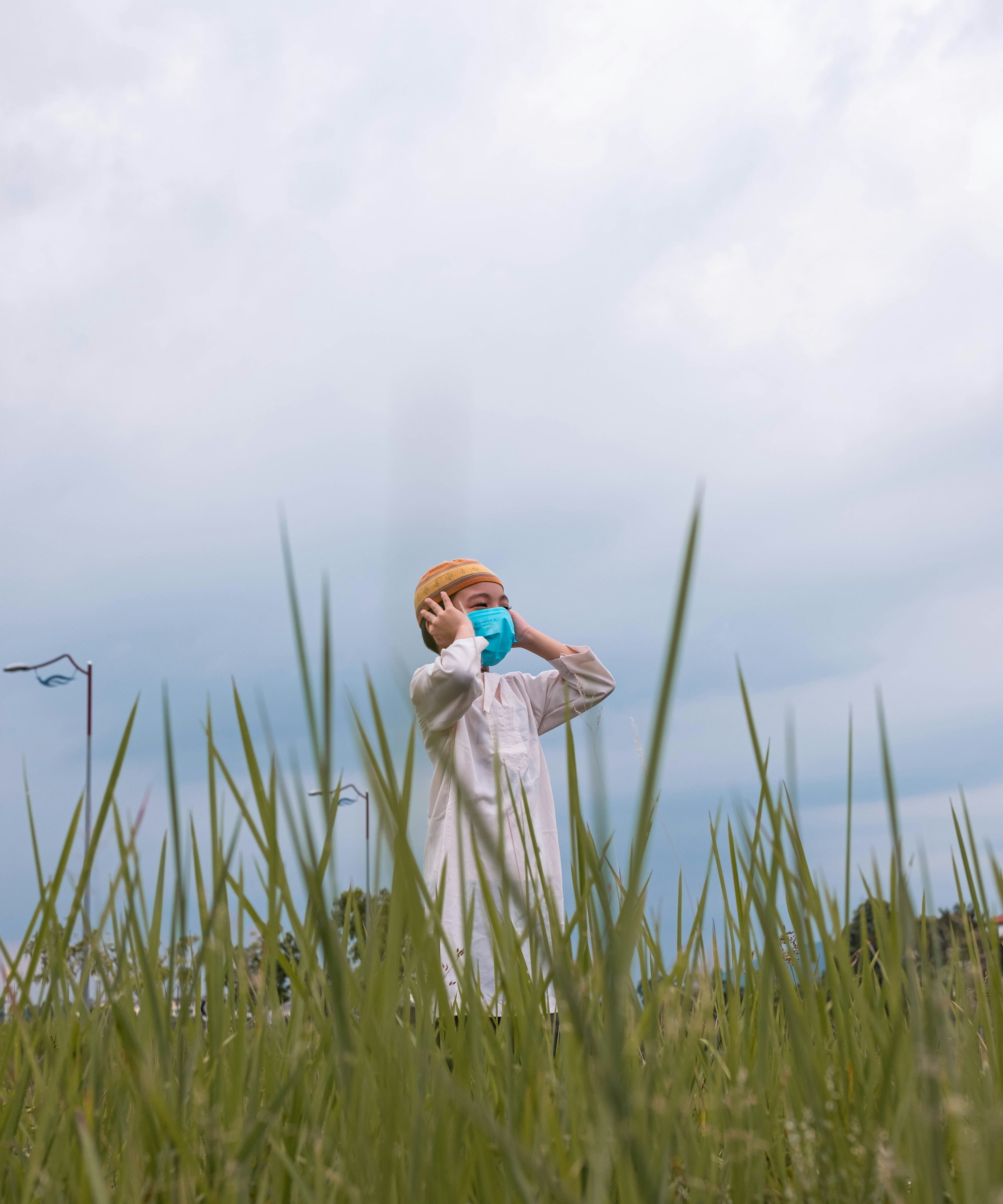 A person standing in a field of tall grass photo – Free Mask Image on ...