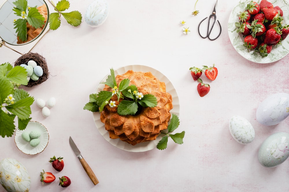 a table topped with plates of food and utensils