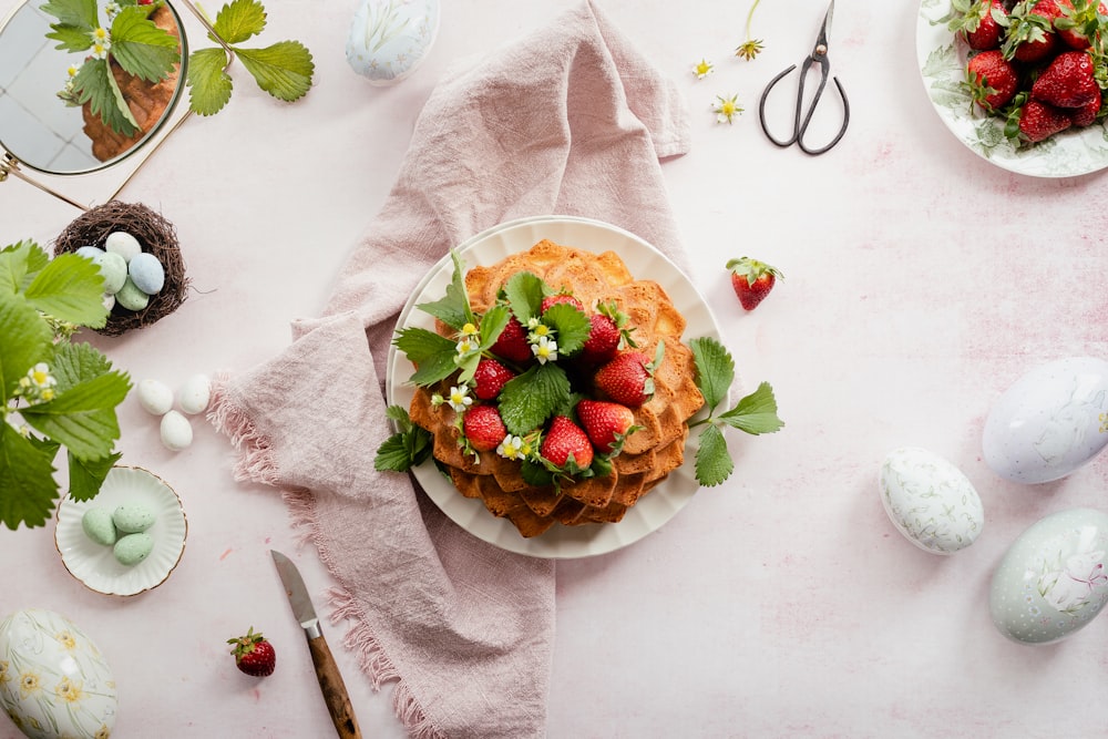 a plate of food with strawberries on top of it