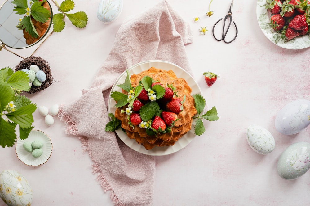 a plate of waffles with strawberries on top