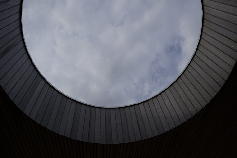 a round window with a sky in the background