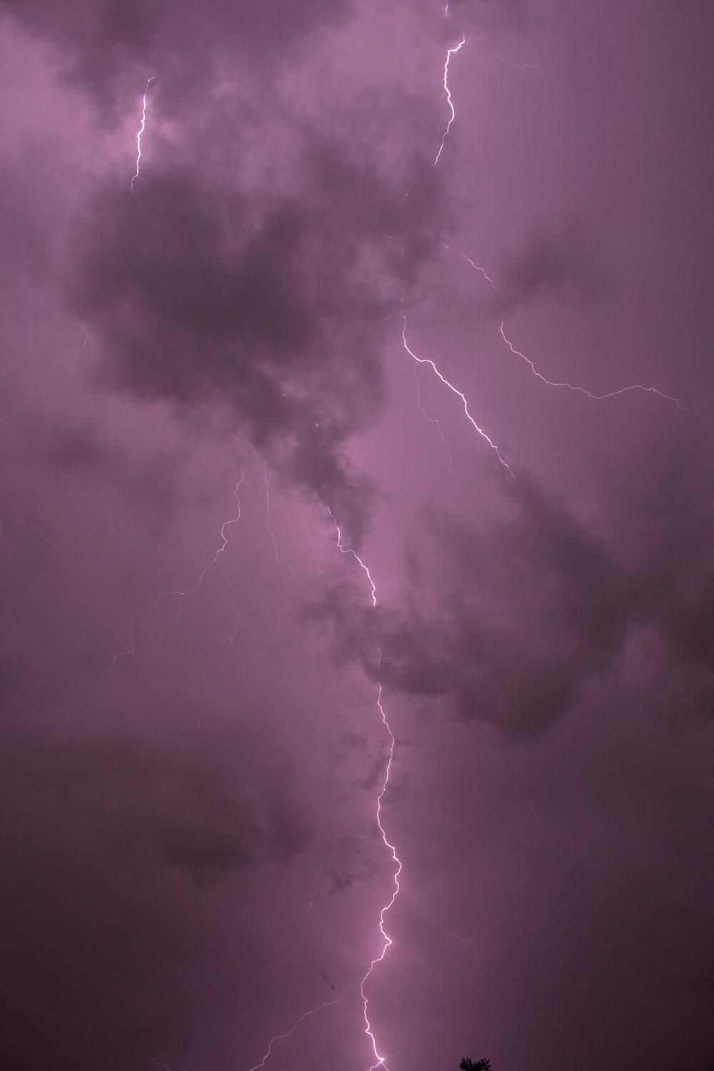 a purple sky with a lightning bolt in the middle of it