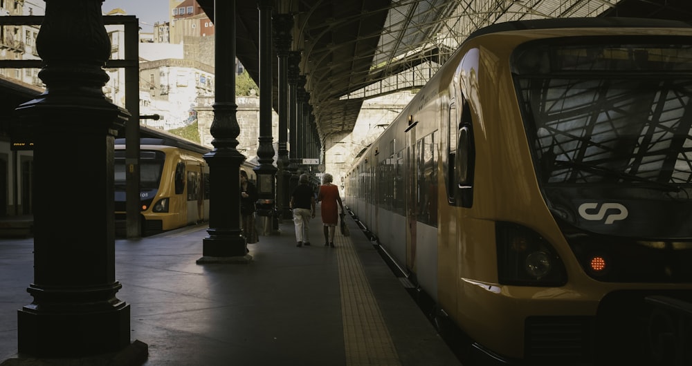 a yellow train pulling into a train station