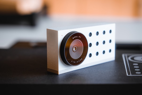 Lifestyle shot of a person using a compact utility product on a light grey countertop, emphasizing ease and function.