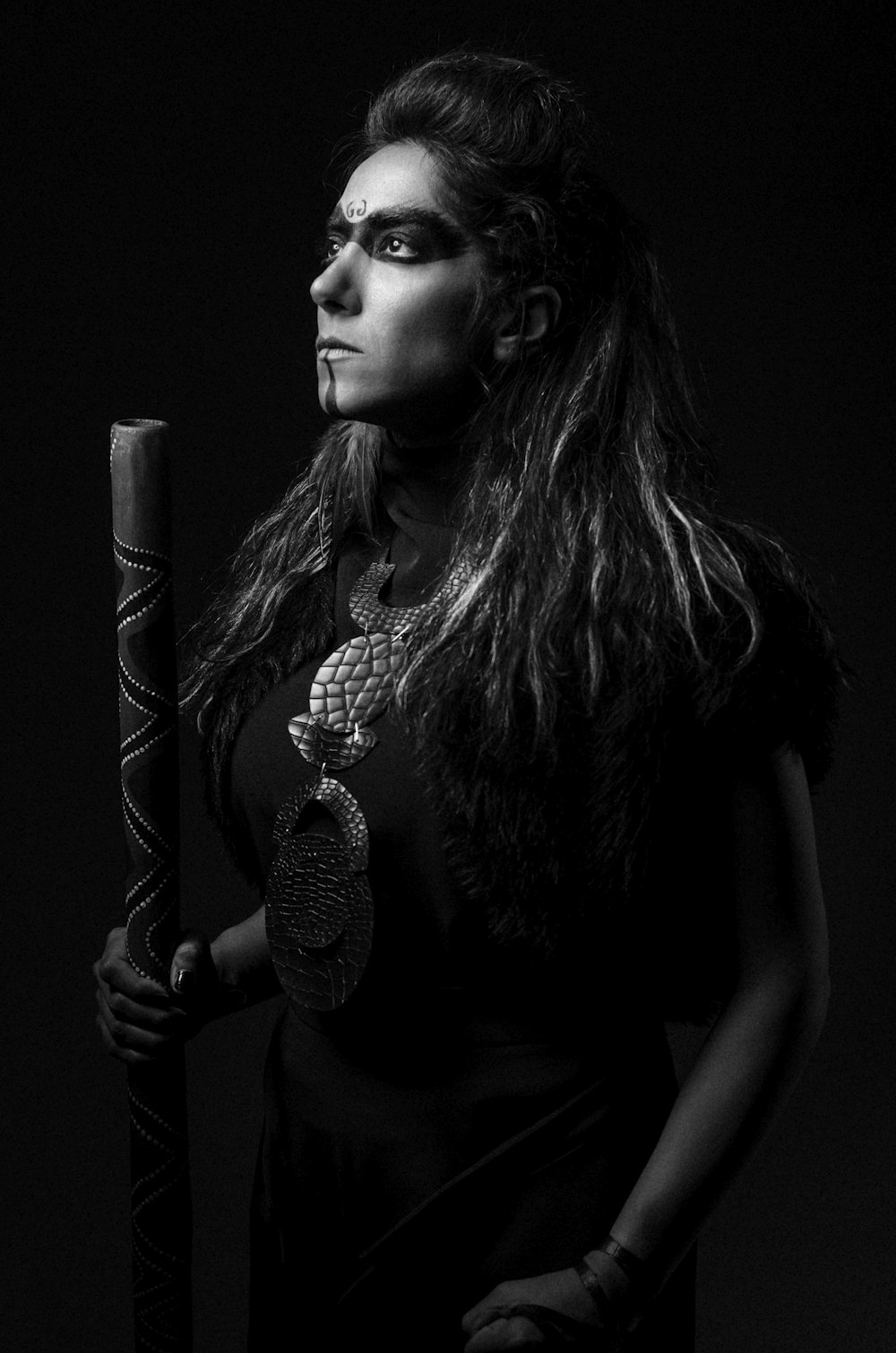 a woman with long hair holding a baseball bat