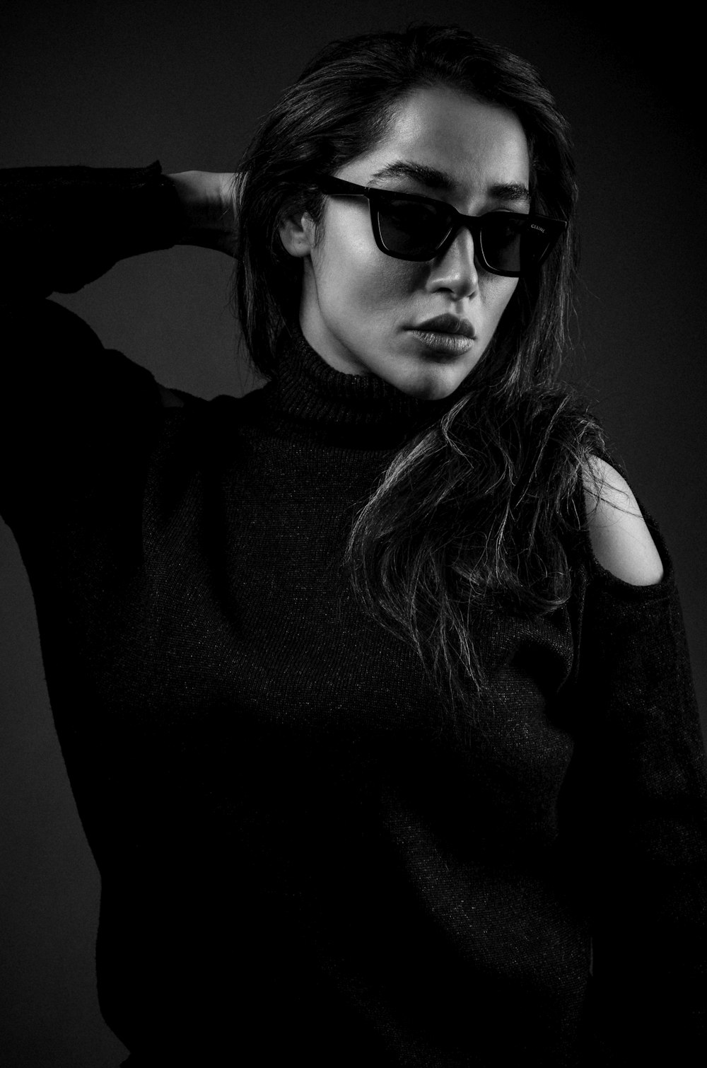 a woman in a black sweater and sunglasses
