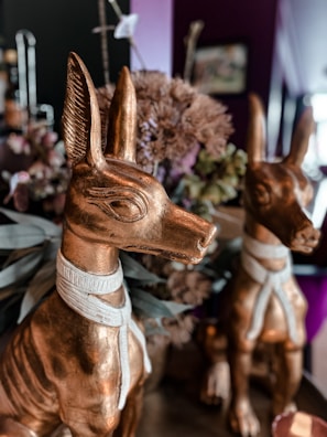 Pink Anubis posing with colorful artwork for a new release.