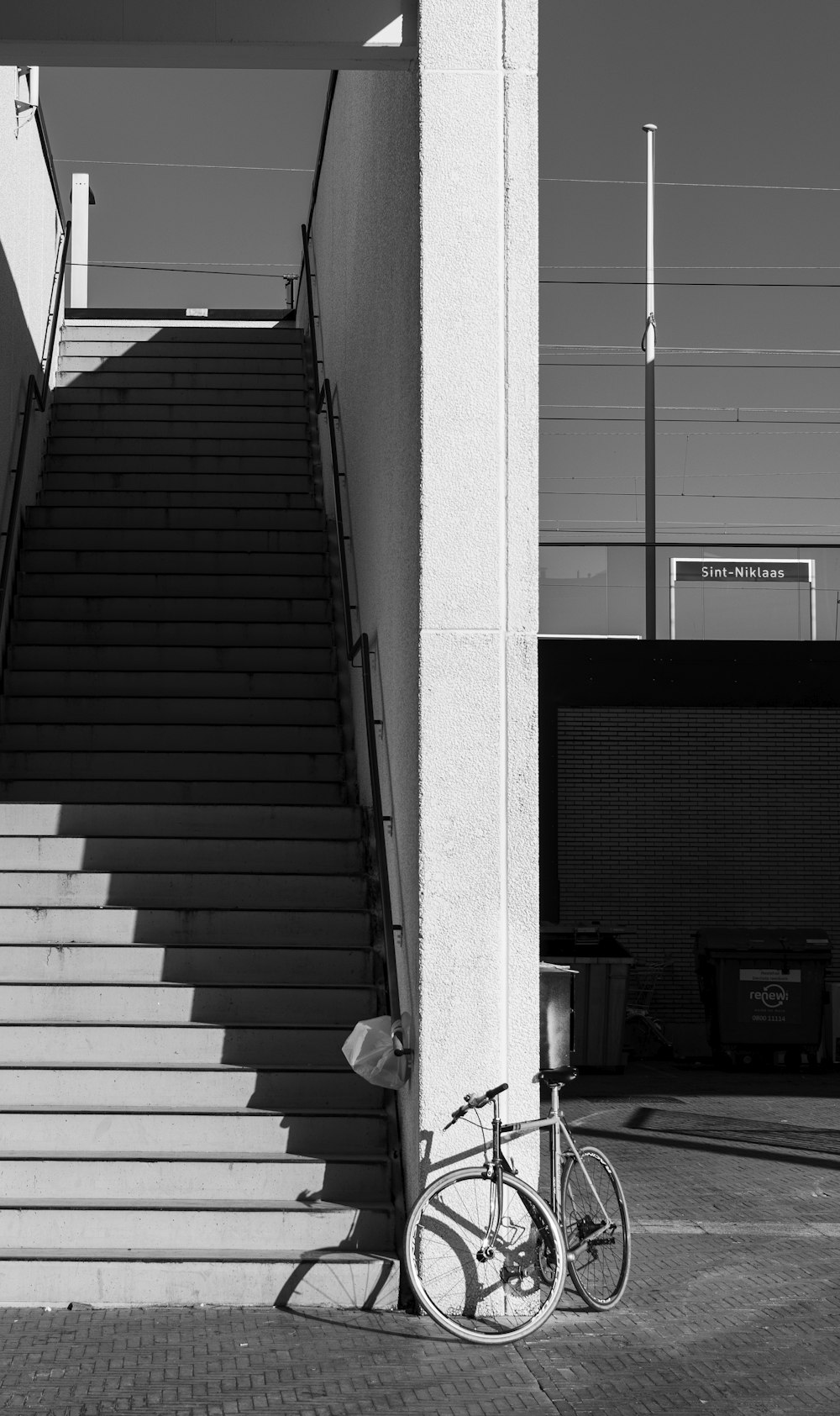 a bike parked next to a set of stairs