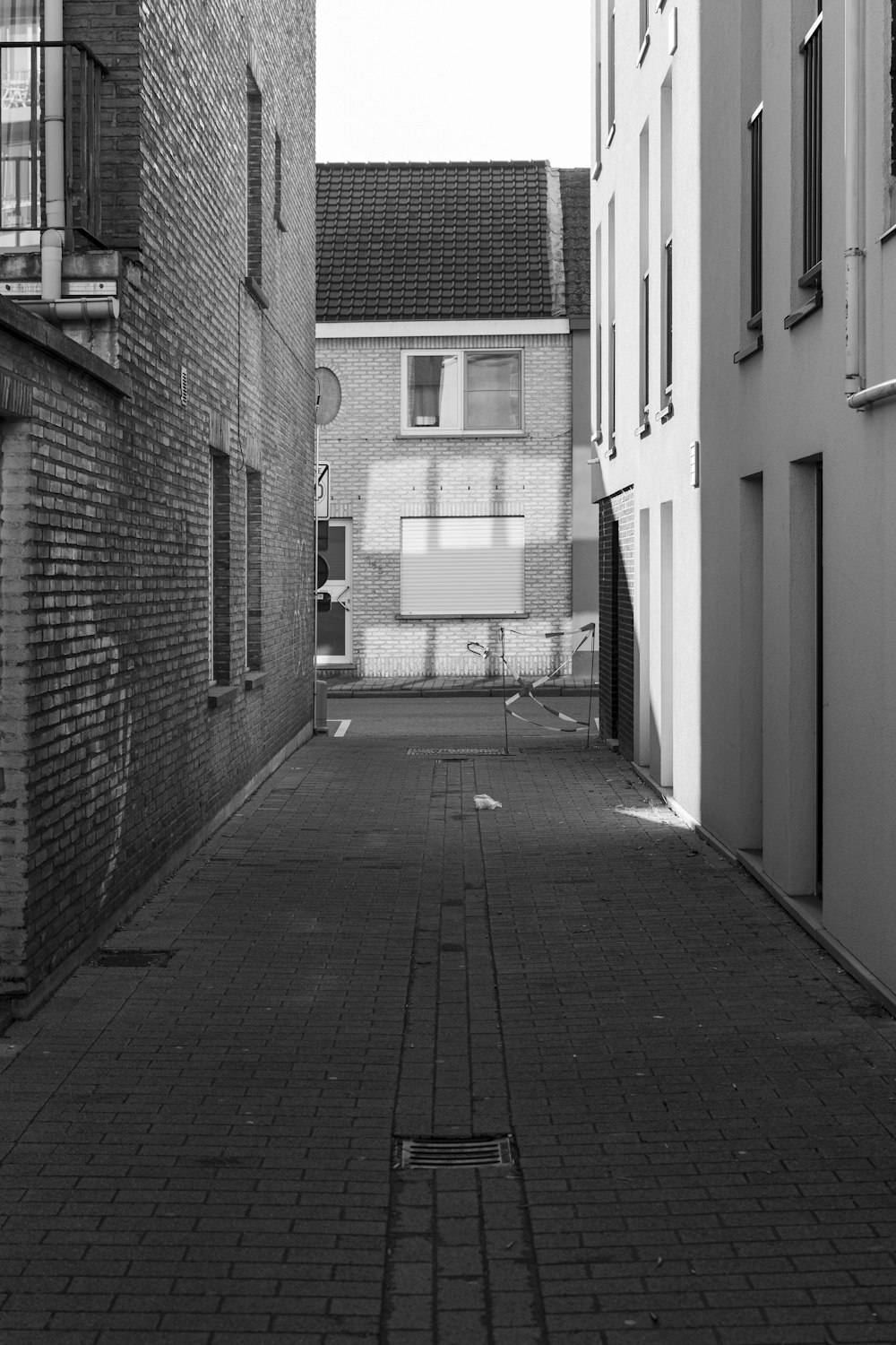 a black and white photo of an alley way