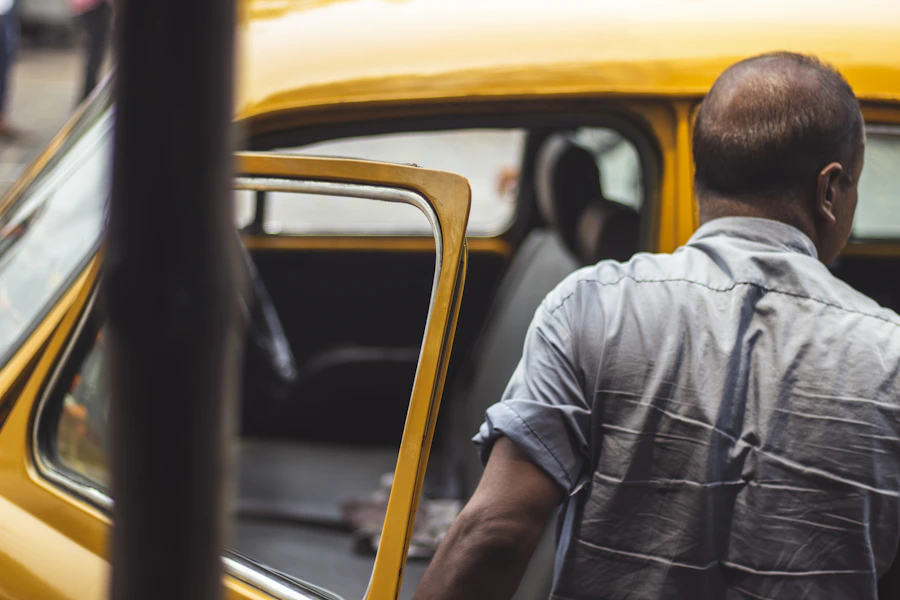 Passenger getting out of Indian taxi