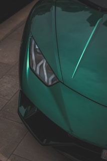 a close up of the front of a green sports car