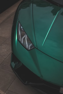 a close up of the front of a green sports car