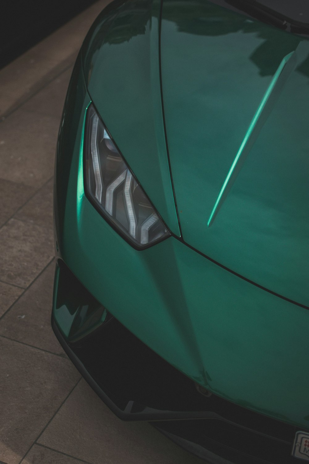 a close up of the front of a green sports car