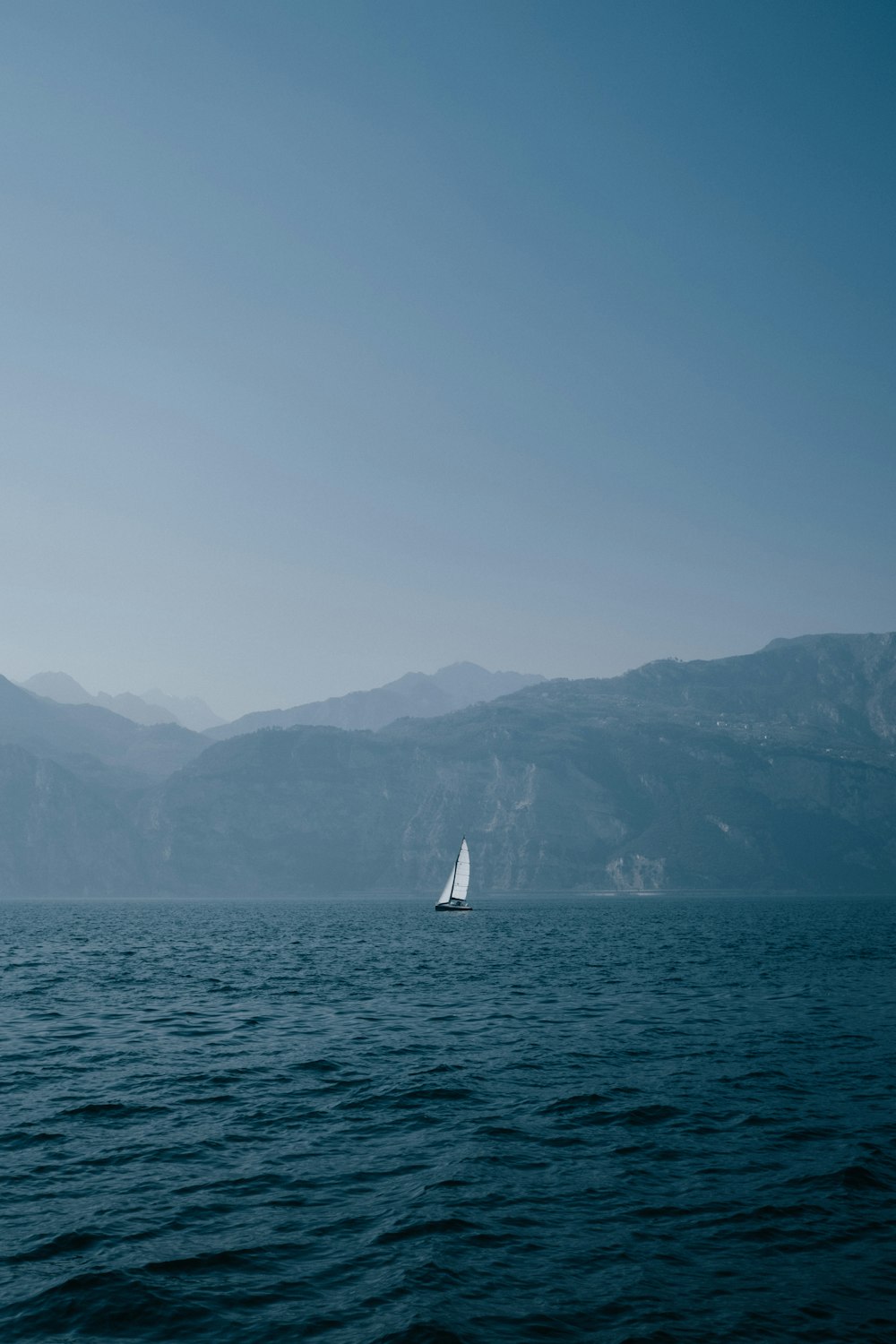 a sailboat in the middle of a body of water