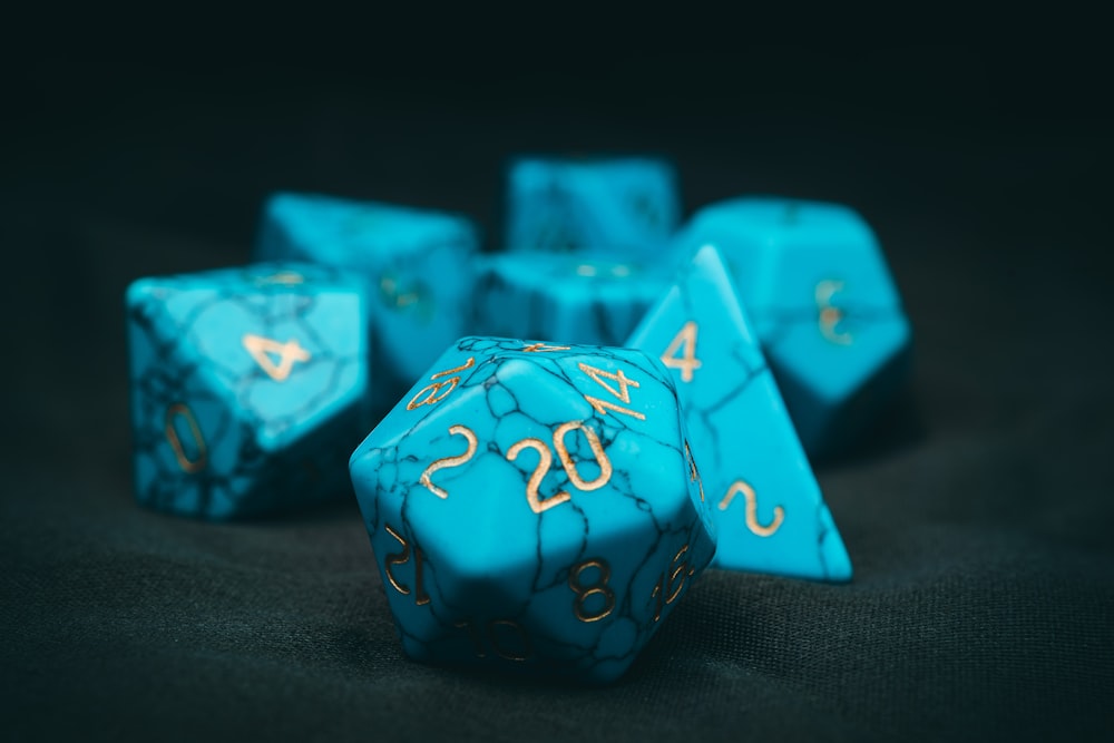 a close up of a blue dice with gold numbers