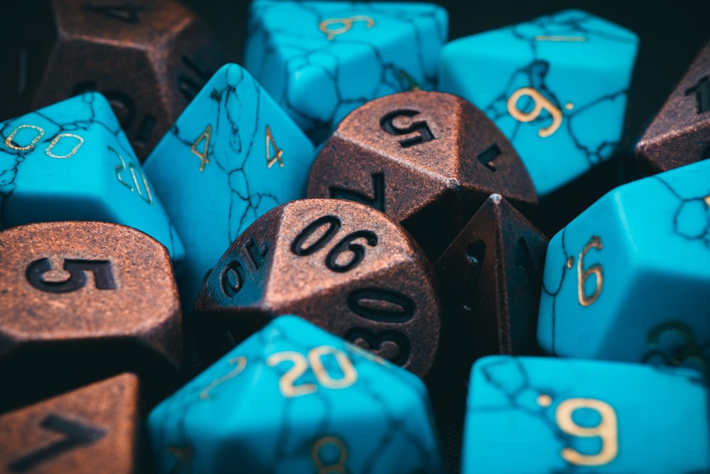 a bunch of blue and brown dice with numbers on them