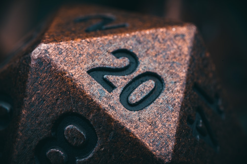 a metal dice with the number twenty on it