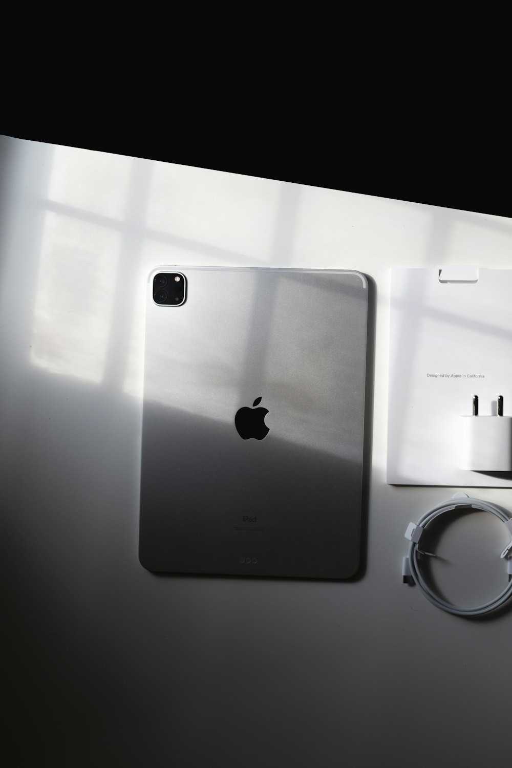 an apple phone and charger on a table