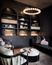 a living room filled with furniture and a book shelf