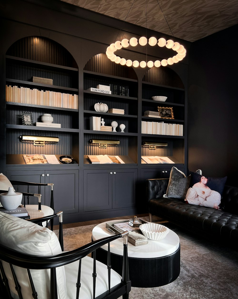 a living room filled with furniture and a book shelf