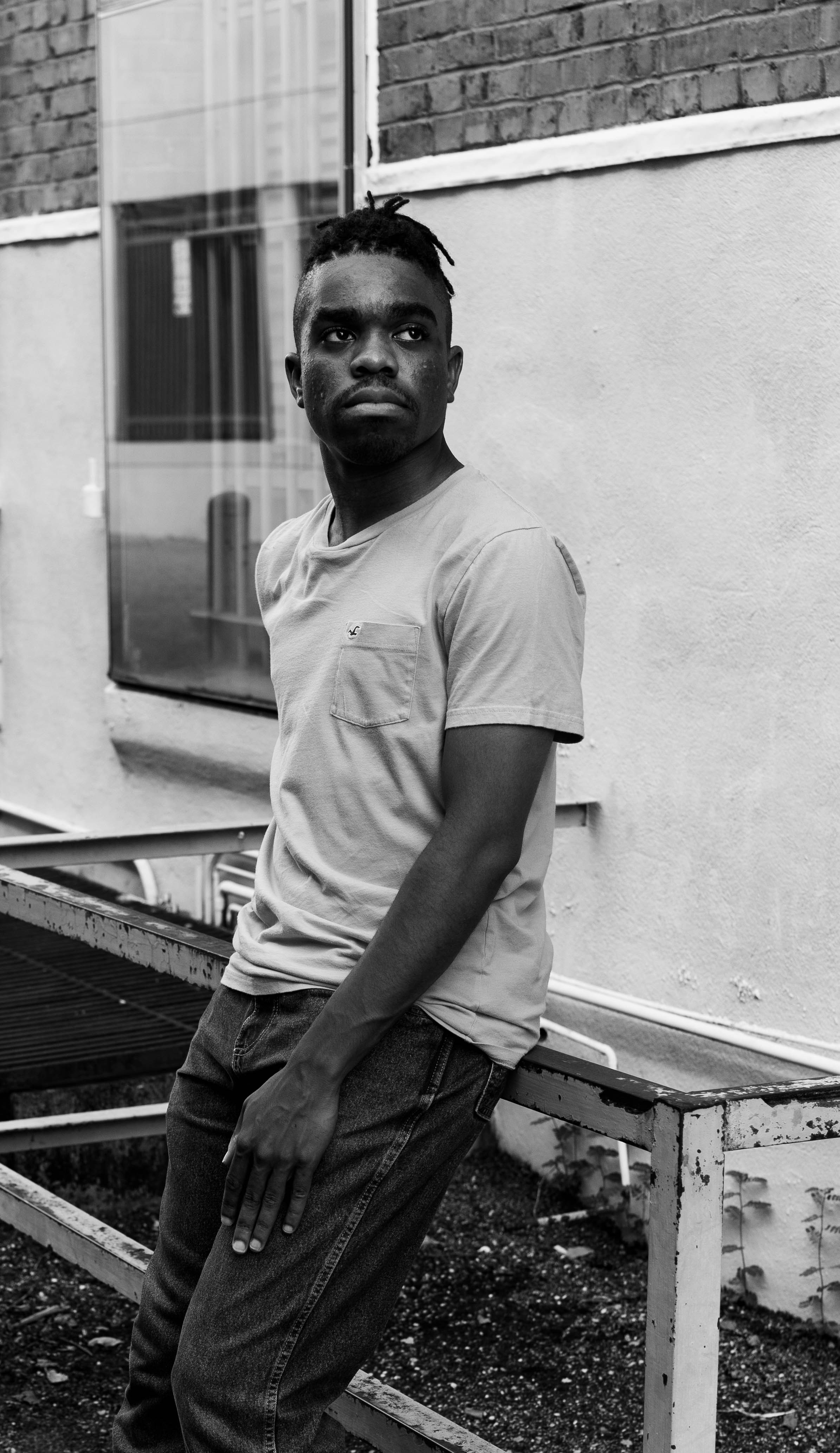 a man standing on a bench in front of a building